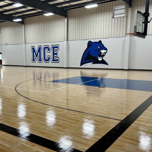 Students and staff are immersed in school spirit daily with this wall in their elementary gym.