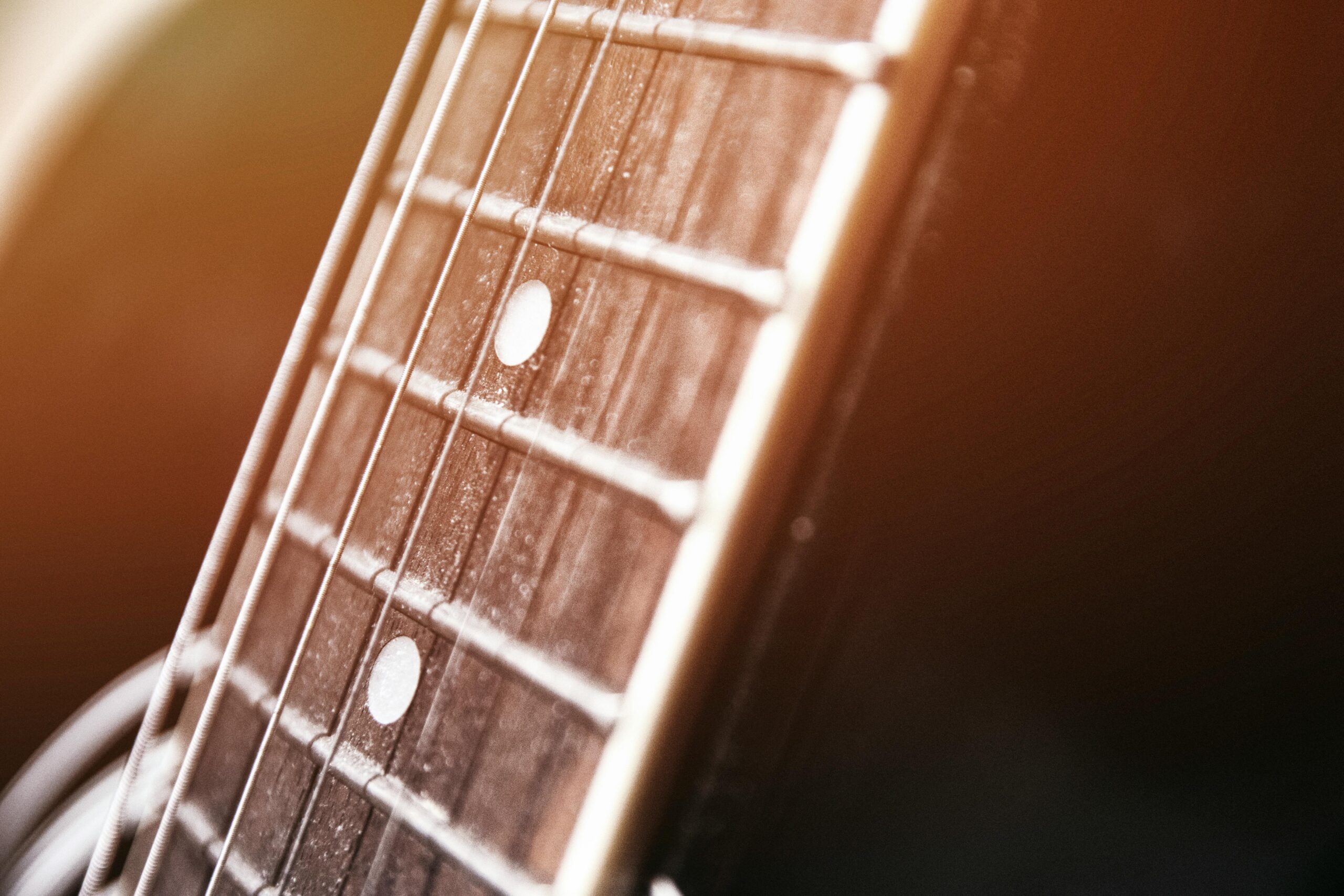 Detailed view of acoustic guitar strings, highlighting the texture and craftsmanship.